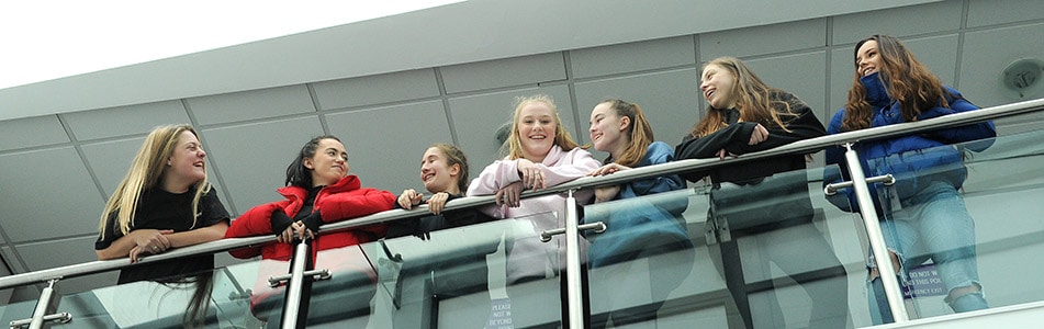 girls laughing on a balcony